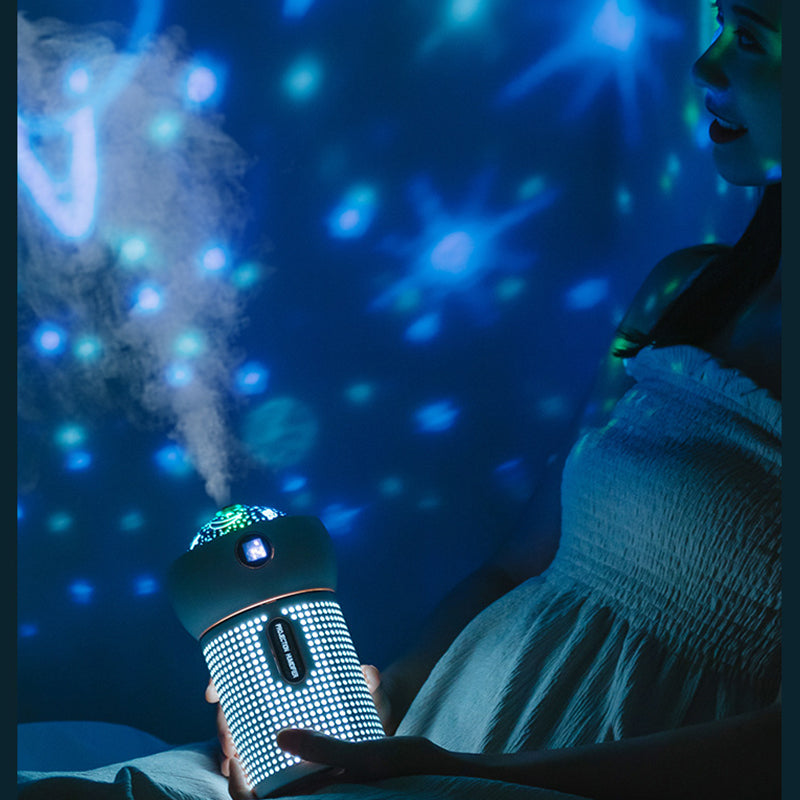 Projection night light humidifier in use, creating a soothing atmosphere with mist and colorful lights.