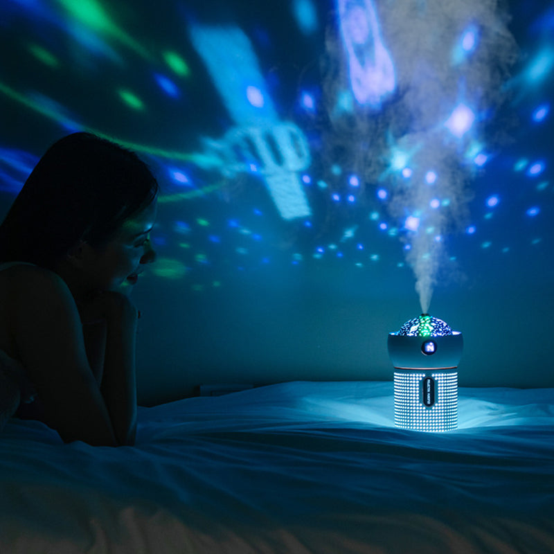 Projection night light humidifier illuminating a room with colorful lights and mist, as a person enjoys the ambiance.